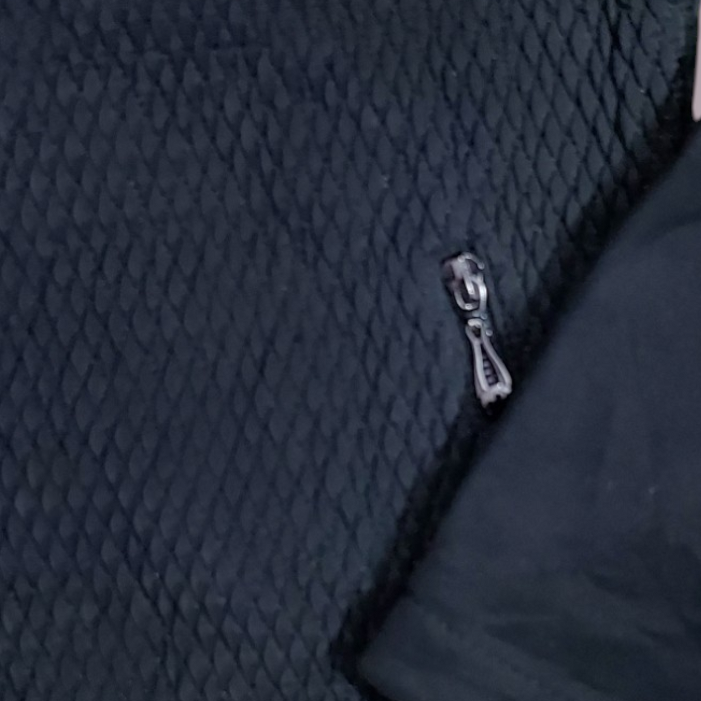 Women's bomber jacket with a textured diamond pattern and a full zip closure.