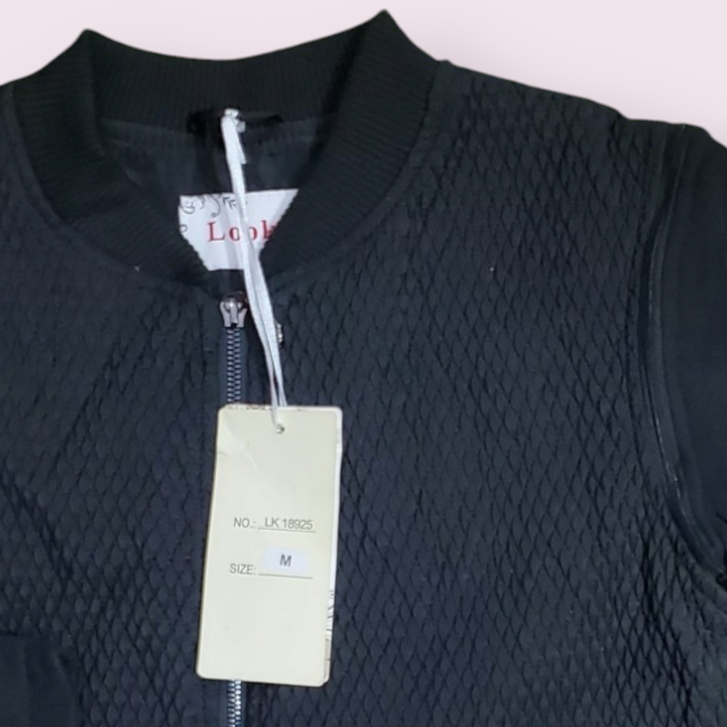 Women's bomber jacket with a textured diamond pattern and a full zip closure.